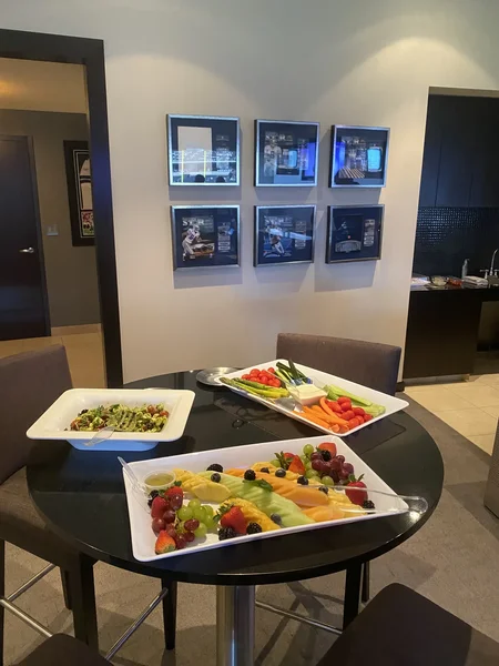 Fruit, vegetable and avocado salad platters on a table in an Owners Club suite
