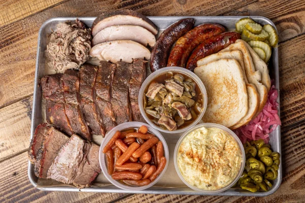Strouderosa barbecue platter with ribs, brisket, turkey, sausage, toast, pickles and sides