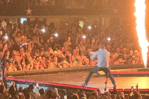 Concert Tickets - Performer working the runway as a flame jet erupts beside the front rows - Dallas VIP