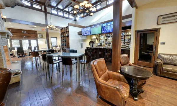 Frisco Gun Club - Clubhouse bar with leather armchairs, high-top tables and game-day screens - DallasVIP