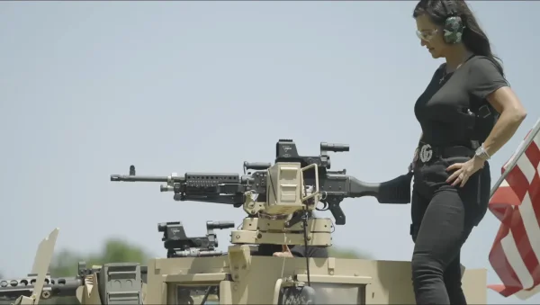 Frisco Gun Club - Guest beside a Humvee-mounted machine gun on the outdoor range - DallasVIP